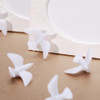 Scattered white plastic doves