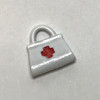 Tiny white painted metal nurse's bag with red cross
