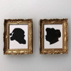 Dollhouse miniature Santa and Mrs. Claus silhouettes in ornate, gold-tone picture frames