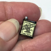 Miniature fly fluid tin shown in hand