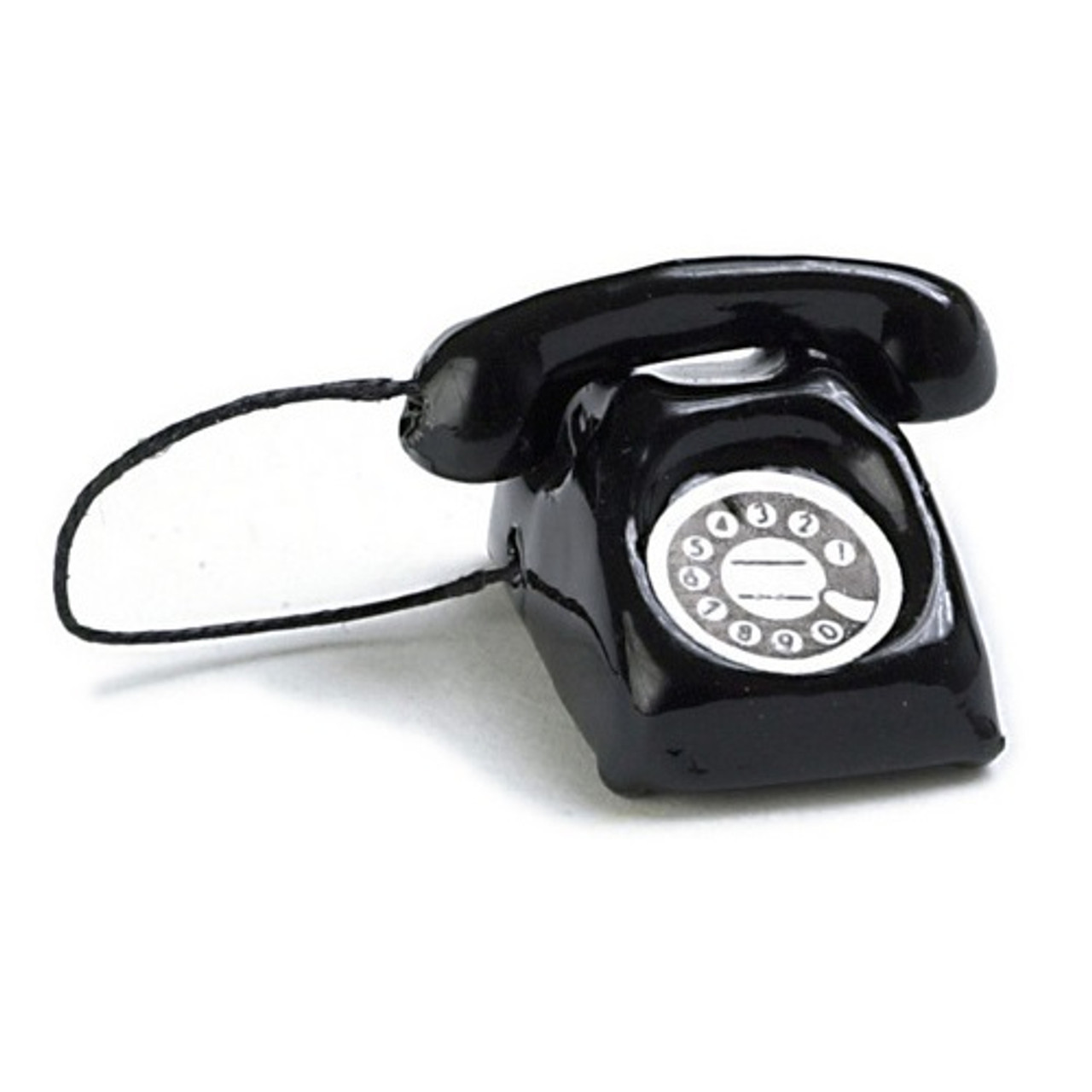 Image of miniature black rotary dial phone on white background