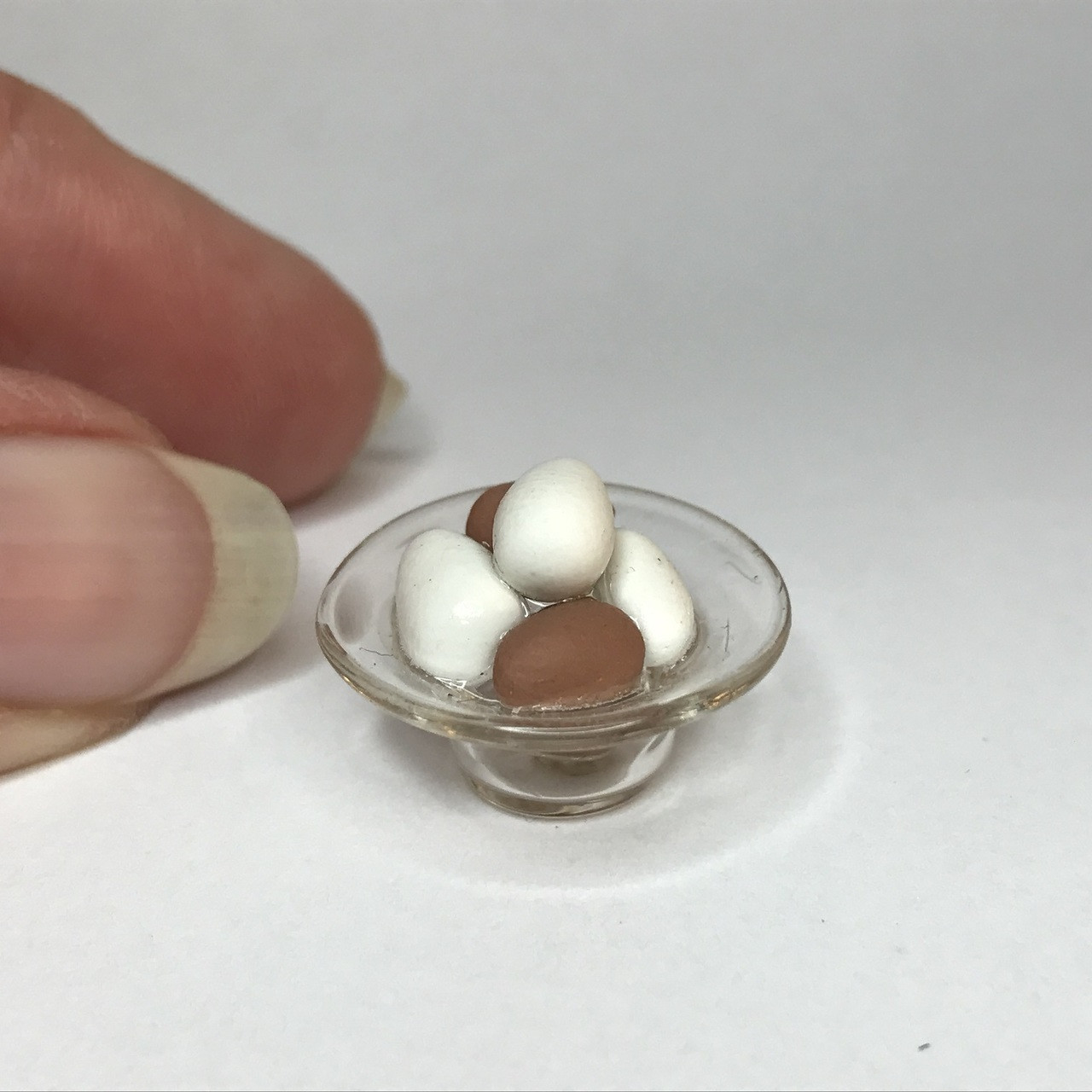 Alternate view of miniature glass bowl with brown and white eggs