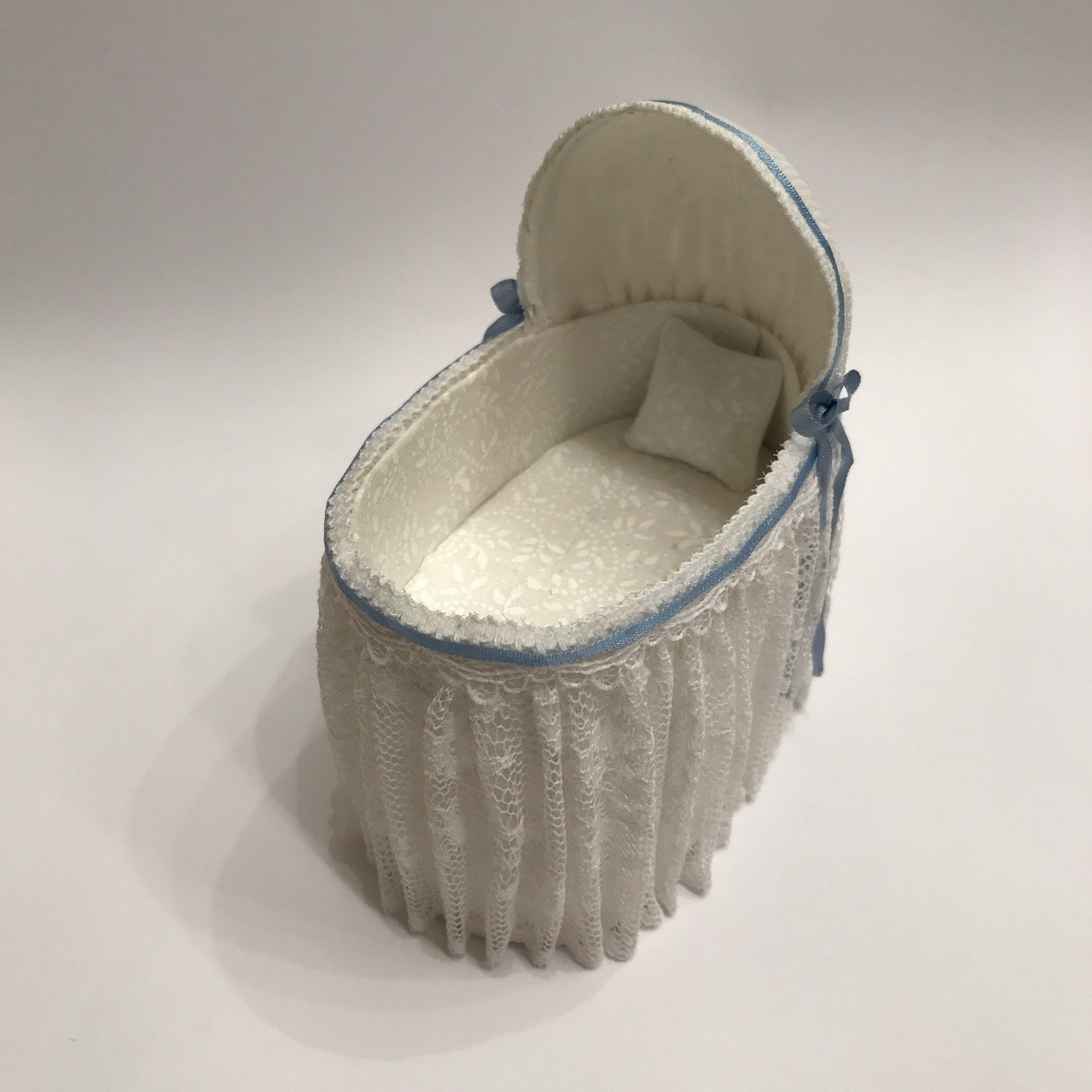 White lace miniature bassinet as viewed from top 