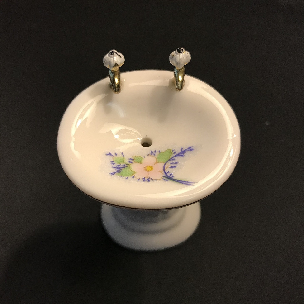 Top of dollhouse pedestal sink showing floral painted basin interior