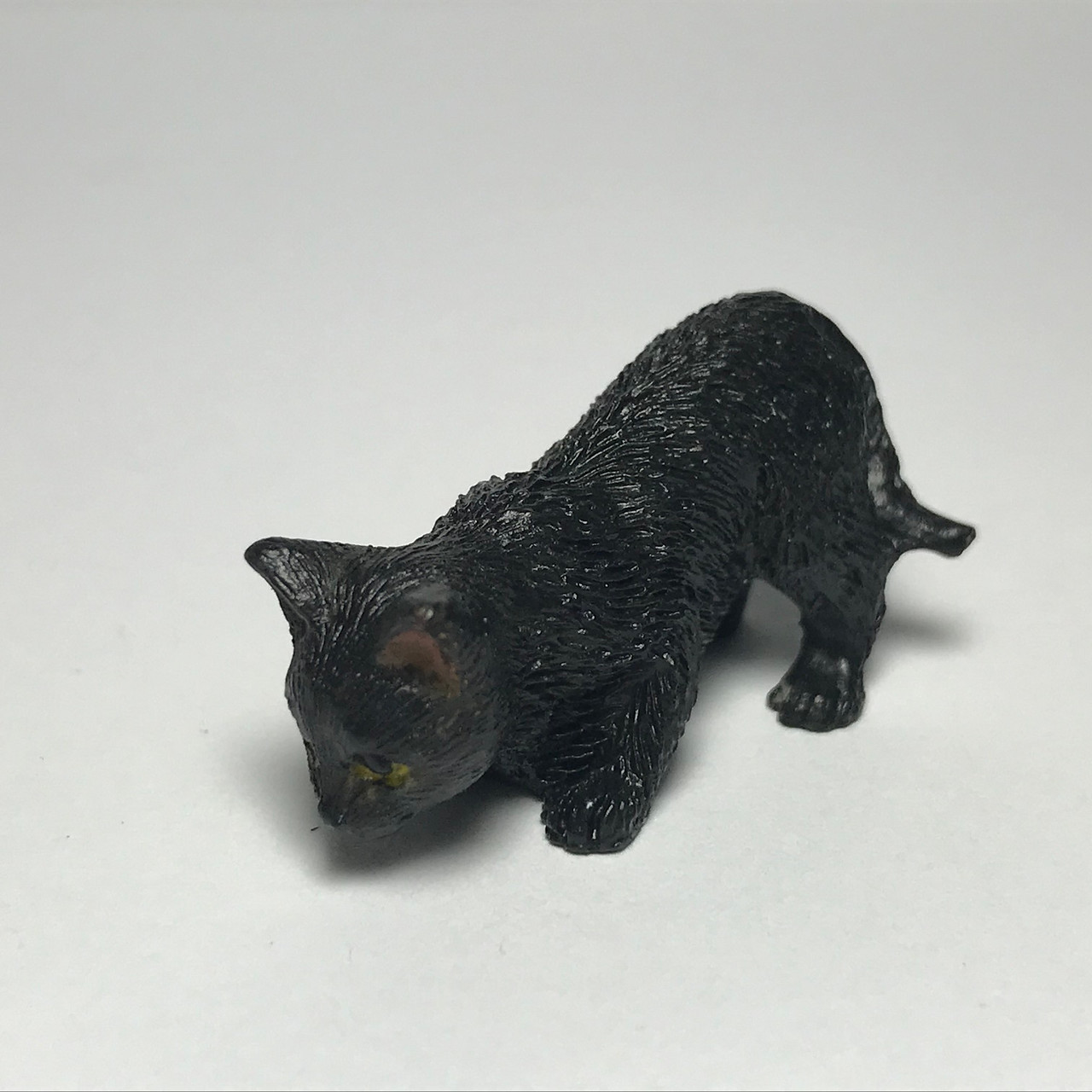 Cute black and white porcelain kitten is ready to pounce!