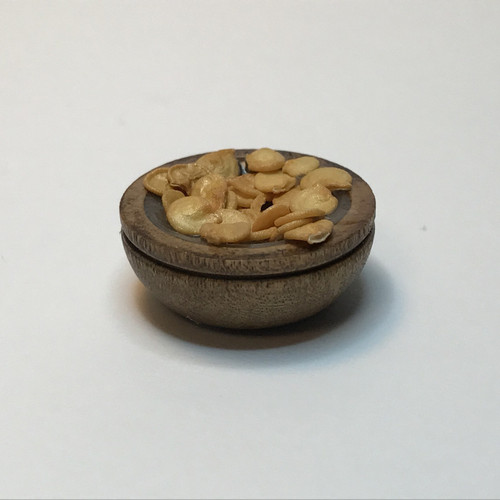 Miniature wooden bowl filled with chips