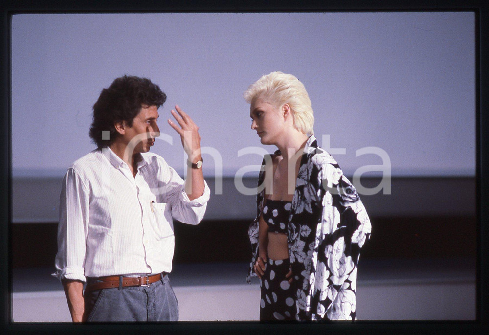35mm vintage slide* 1985ca Anna OXA con il regista Raul MORALES   Diapositiva d'epoca, in formato 35 mm. CONDIZIONI: GOODE' severamente vietata la riproduzione. Tutti i diritti sono riservati. ICharta mette in vendita, sul negozio eBay e in esclusiva sul sito "icharta" il proprio archivio composto da numerose diapositive e negativi fotografici d'epoca, tutti originali e autentici, che attraversano la storia del costume italiano tra gli la fine degli anni Sessanta e Novanta.Si tratta di uno sguardo inedito sull'attualit&agrave;, la politica, la vita quotidiana, il gossip e la cultura, che fotografa il cambiamento della nazione in quest'ultimo scorcio del XX secolo. Un'occasione unica per il mercato del collezionismo, che vede finalmente disponibile un archivio eccezionale per vastit&agrave;, tematiche e condizioni, in un settore (il negativo fotografico e la diapositiva) di assoluta novit&agrave; e dalle interessanti prospettive di investimento.     originale e autentica 1