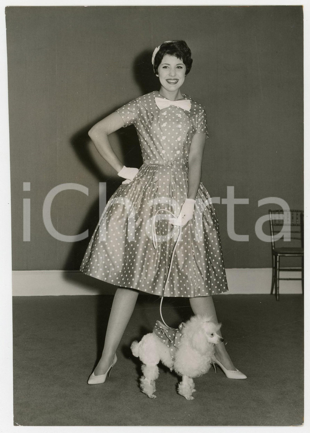1958 LONDON Ascot Models' Spring collection - Model posing with a poodle *Photo
