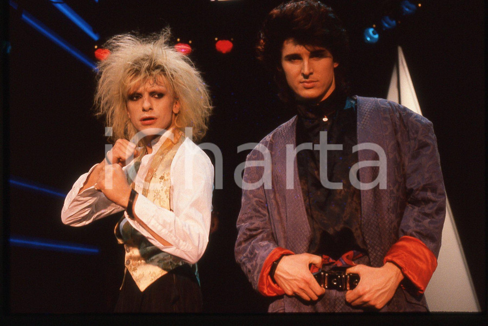 35mm vintage slide* 1985 FESTIVALBAR Markus MORL Mark JEFFERIS dei T.X.T. (6) Diapositiva d'epoca, in formato 35 mm. CONDIZIONI: GOODE' severamente vietata la riproduzione. Tutti i diritti sono riservati. ICharta mette in vendita, sul negozio eBay e in esclusiva sul sito "icharta" il proprio archivio composto da numerose diapositive e negativi fotografici d'epoca, tutti originali e autentici, che attraversano la storia del costume italiano tra gli la fine degli anni Sessanta e Novanta.Si tratta di uno sguardo inedito sull'attualit&agrave;, la politica, la vita quotidiana, il gossip e la cultura, che fotografa il cambiamento della nazione in quest'ultimo scorcio del XX secolo. Un'occasione unica per il mercato del collezionismo, che vede finalmente disponibile un archivio eccezionale per vastit&agrave;, tematiche e condizioni, in un settore (il negativo fotografico e la diapositiva) di assoluta novit&agrave; e dalle interessanti prospettive di investimento.  originale e autentica 1