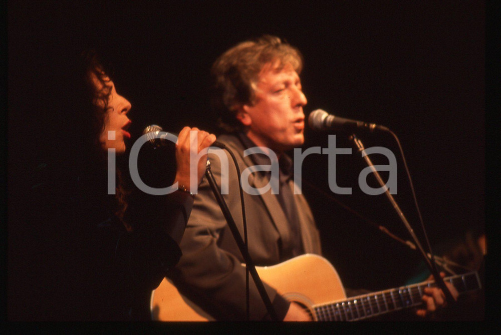 35mm vintage slide* 1985ca ITALIA MUSICA Mario LAVEZZI Giulia FASOLINO Live 7 Diapositiva d'epoca, in formato 35 mm. CONDIZIONI: GOODE' severamente vietata la riproduzione. Tutti i diritti sono riservati. ICharta mette in vendita, sul negozio eBay e in esclusiva sul sito "icharta" il proprio archivio composto da numerose diapositive e negativi fotografici d'epoca, tutti originali e autentici, che attraversano la storia del costume italiano tra gli la fine degli anni Sessanta e Novanta.Si tratta di uno sguardo inedito sull'attualit&agrave;, la politica, la vita quotidiana, il gossip e la cultura, che fotografa il cambiamento della nazione in quest'ultimo scorcio del XX secolo. Un'occasione unica per il mercato del collezionismo, che vede finalmente disponibile un archivio eccezionale per vastit&agrave;, tematiche e condizioni, in un settore (il negativo fotografico e la diapositiva) di assoluta novit&agrave; e dalle interessanti prospettive di investimento.  originale e autentica 1