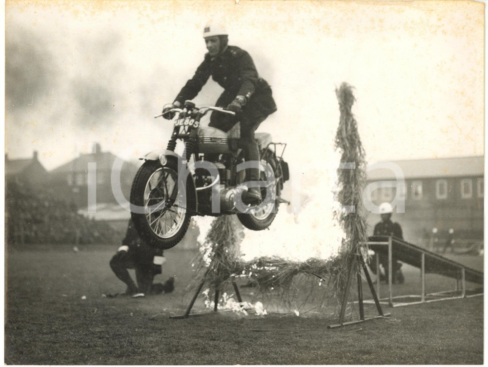 1957 CATTERICK CAMP - Rider of ROYAL CORPS OF SIGNALS jump through flaming hoop