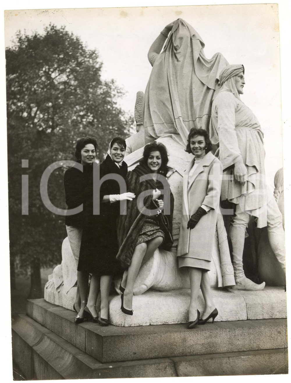 1959 LONDON ALBERT MEMORIAL Miss World contestants sitting on one of the statues