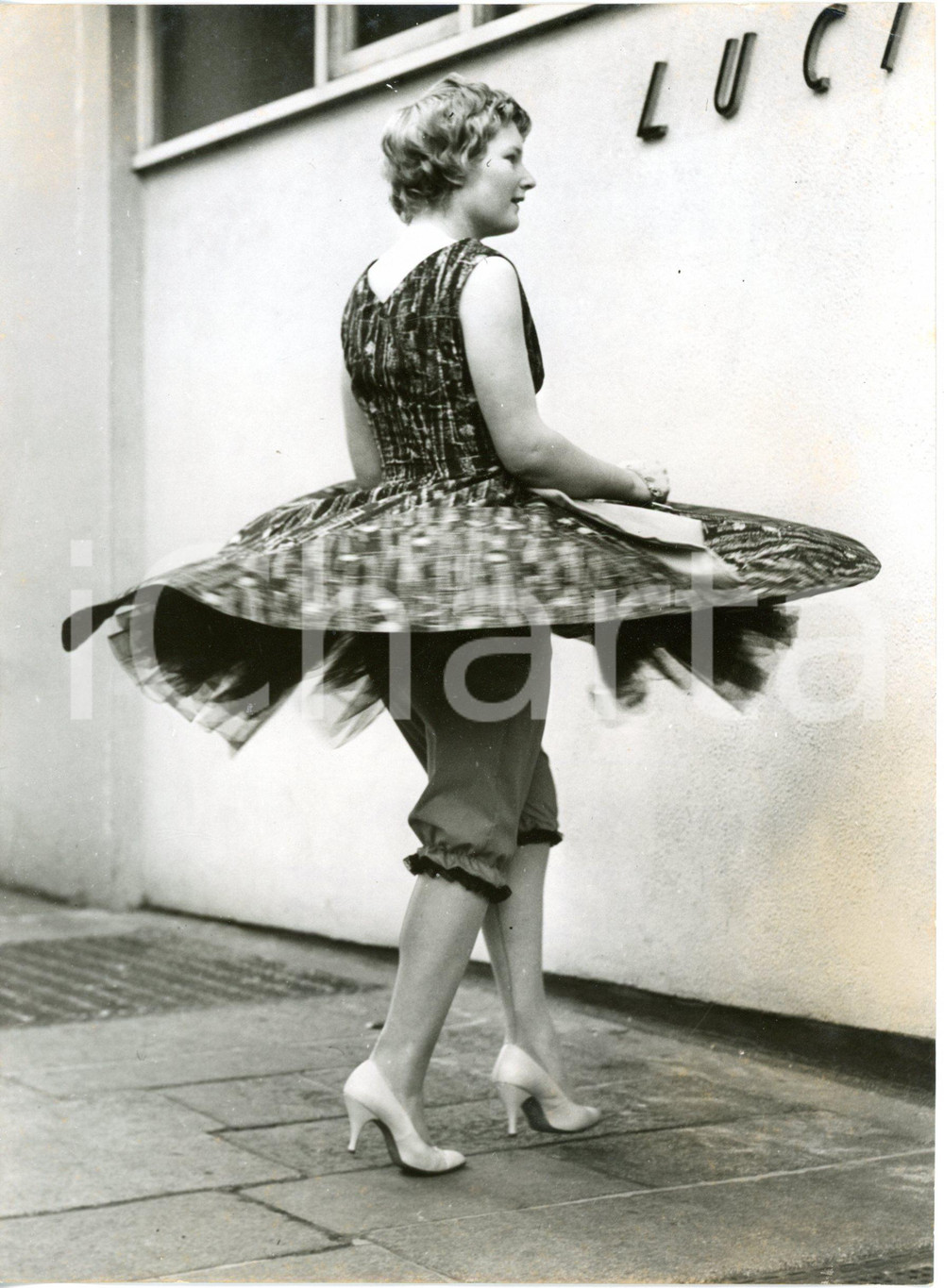 1959 LONDON - FASHION Judy EUSTACE showing her trousers under the new dress
