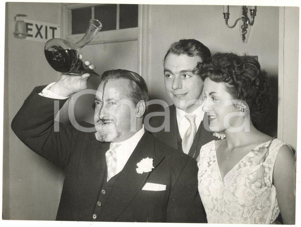 1954 LONDON - Restaurateur J. SOLSONA demonstrating a novel way to drink a toast