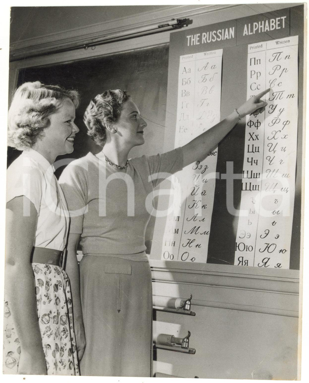 1958 TORONTO - Helen COX instructing a student in the Russian alphabet *Photo