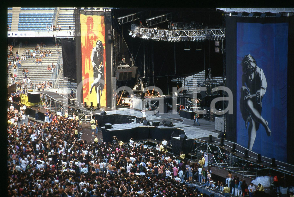 35mm vintage slide * 1992 TORINO GUNS N' ROSES Fans in attesa del concerto (2)   Diapositiva d'epoca, in formato 35 mm.   CONDIZIONI: GOODE' severamente vietata la riproduzione. Tutti i diritti sono riservati. ICharta mette in vendita, sul negozio eBay e in esclusiva sul sito "icharta" il proprio archivio composto da numerose diapositive e negativi fotografici d'epoca, tutti originali e autentici, che attraversano la storia del costume italiano tra gli la fine degli anni Sessanta e Novanta.Si tratta di uno sguardo inedito sull'attualit&agrave;, la politica, la vita quotidiana, il gossip e la cultura, che fotografa il cambiamento della nazione in quest'ultimo scorcio del XX secolo. Un'occasione unica per il mercato del collezionismo, che vede finalmente disponibile un archivio eccezionale per vastit&agrave;, tematiche e condizioni, in un settore (il negativo fotografico e la diapositiva) di assoluta novit&agrave; e dalle interessanti prospettive di investimento.  originale e autentica 1