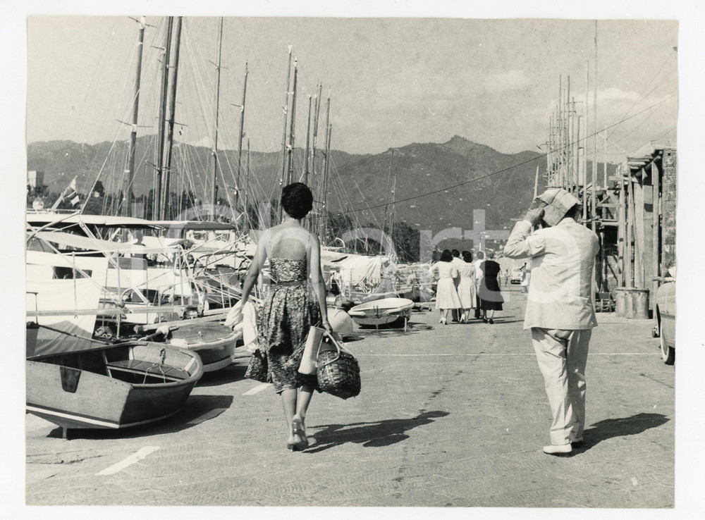 1958 SANTA MARGHERITA LIGURE Totò a passeggio si ripara dal sole (1) Foto 24x18 7 Agosto 1958Fotografia vintage rara d'epoca, nella quale Tot&ograve; e la compagna Franca Faldini sono ritratti di spalle durante una passeggiata.Timbro archivio Publifoto Genova al verso.FORMATO: cm 24X18CONDIZIONI: G (lievi difetti di stampa e ondulatura laterale)ICHARTA mette in vendita le stampe vintage della collezione Publifoto Genova, per la maggior parte inedita o in tiratura di pochi esemplari. Si tratta di un'ottima opportunit&agrave; di investimento per i collezionisti di fotografie d'epoca.      originale e autentica 1