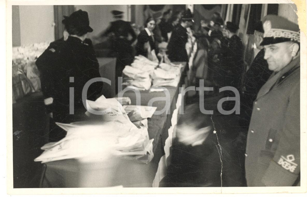 1941 PAVIA PNF Befana del Soldato - Distribuzione pacchi (1) Foto DANNEGGIATA Fotografia d'epoca.CONDIZIONI: VP (profonda piegatura al lato inferiore; minimo taglio al lato destro; abrasione all'angolo superiore destro; residui adesivi al verso)FORMATO: 15x10 cm    originale e autentica 1