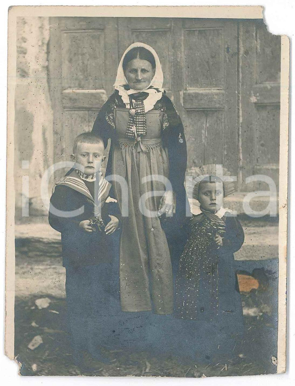 1930 ca s.l. ITALIA Anziana contadina con i due nipoti - Foto DANNEGGIATA  Fotografia d'epoca, in formato cartolina postale. VERY POOR/gravemente danneggiato mancanze angolari; lievi piegature; piccolo foro di affissione; macchia al lato destro Formato: 9x12 cm originale e autentica 1