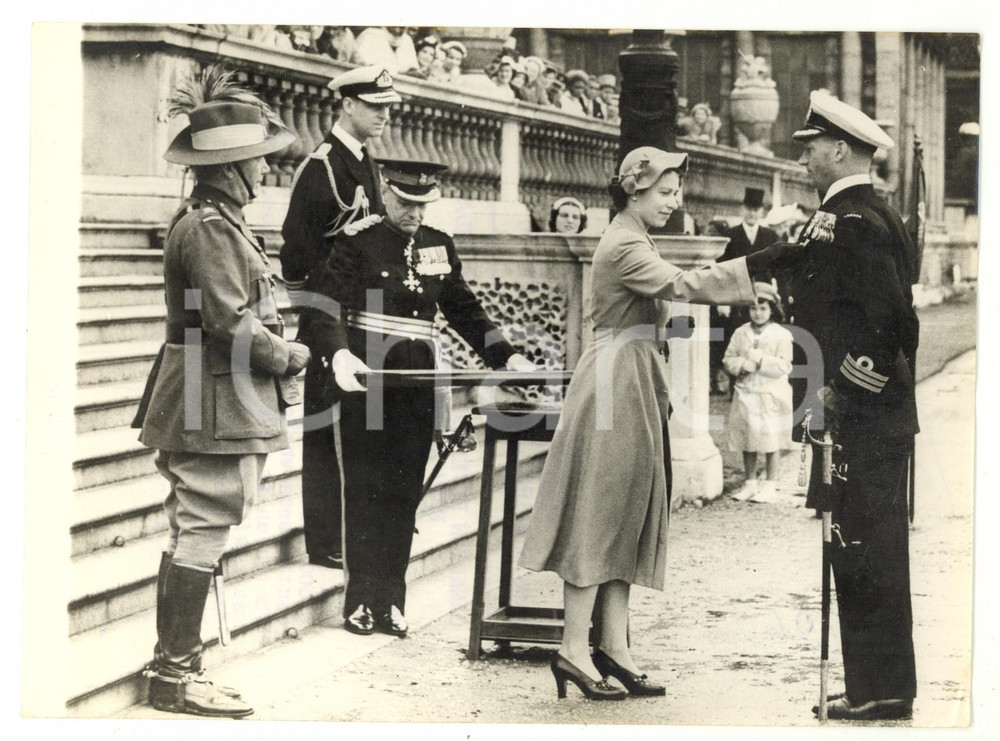 1953 LONDON ELIZABETH II pinning a Coronation Medal on a Canadian naval officer