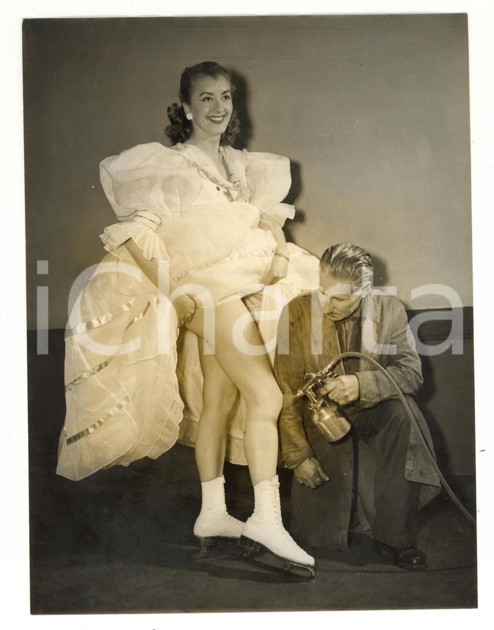 1954 LONDON Fred EDEN putting a neat coating of leg on the skater Shirley BURKE