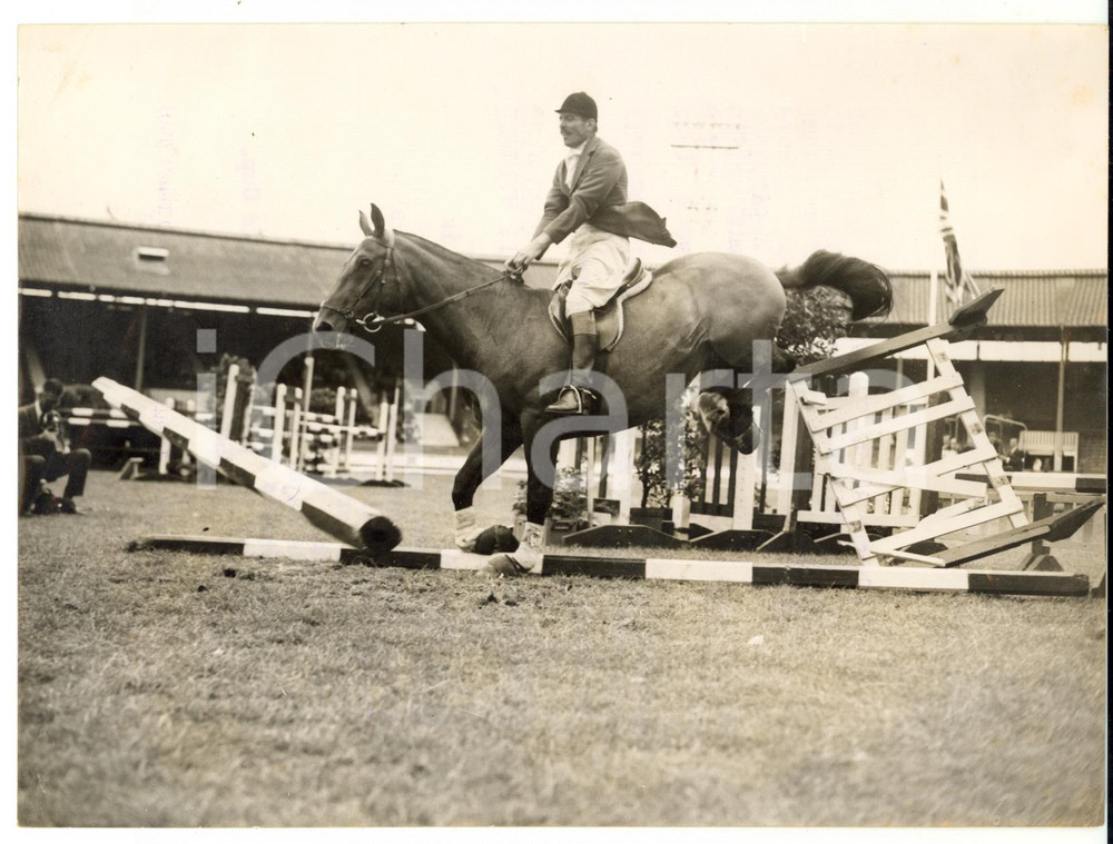 1957 LONDON Chelsea Stakes - Major H. C. SELBY on HEIKO leaving a fence in ruins