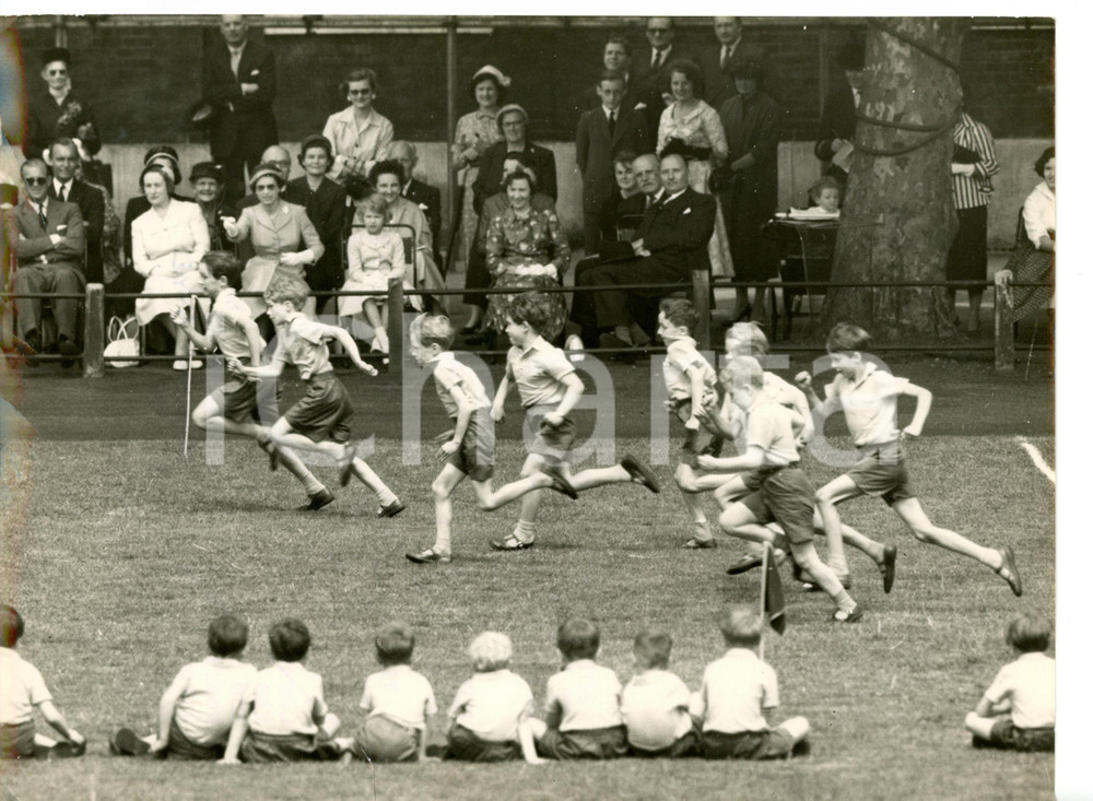 1957 LONDON Queen ELIZABETH II urging Prince CHARLES during a race at his school