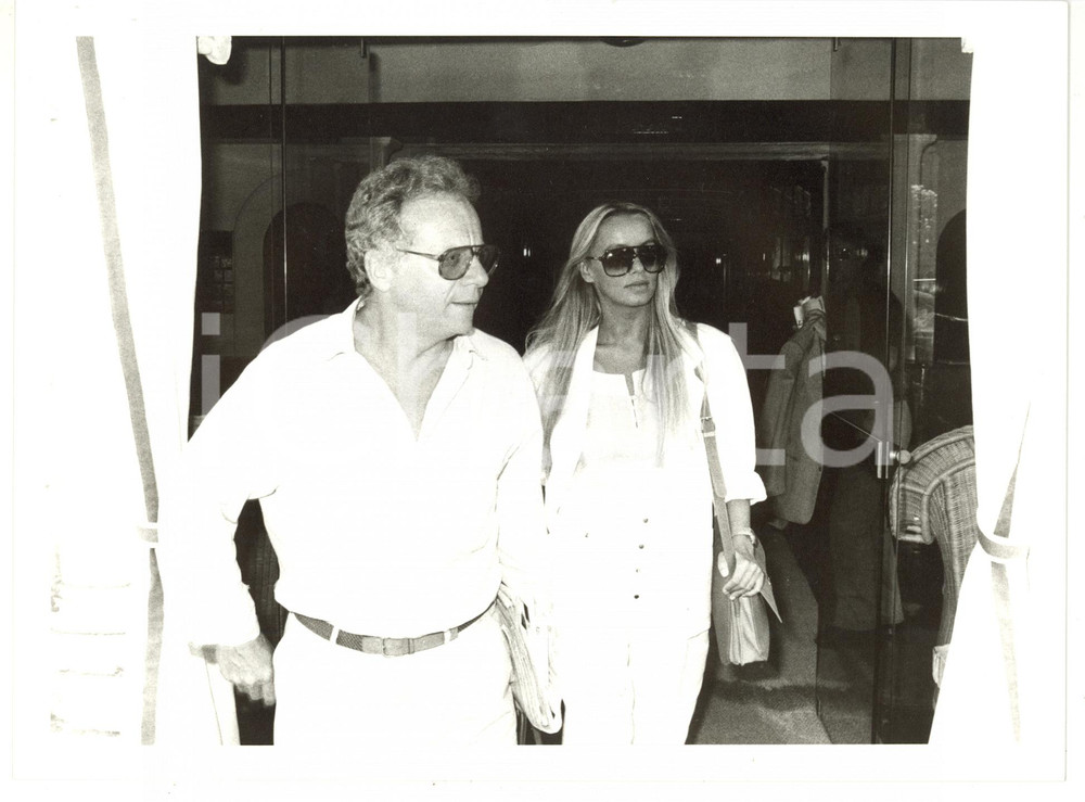 1990 ca COSTUME ITALIA Johnny DORELLI e Gloria GUIDA all'uscita da un hotel FOTO