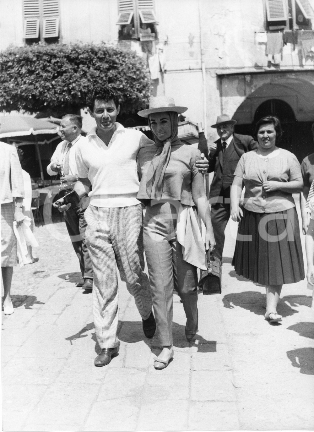1959 PORTOFINO Liz TAYLOR ed Eddie FISHER in piazzetta (2) Foto vintage 18x24 1959Fotografia vintage rara d'epoca.Timbro archivio Publifoto Genova al verso.FORMATO: 18x24 cm CONDIZIONI: G (minimi difetti di stampa)ICHARTA mette in vendita le stampe vintage della collezione Publifoto Genova, per la maggior parte inedita o in tiratura di pochi esemplari. Si tratta di un'ottima opportunit&agrave; di investimento per i collezionisti di fotografie d'epoca.    originale e autentica 1