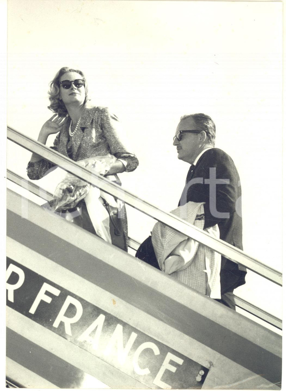 1959 ROMA CIAMPINO Principi Ranieri e Grace di Monaco partono su volo AIR FRANCE  Fotografia d'epoca con didascalia coeva al verso.   CONDIZIONI: G (lieve sovraimpressione circolare) FORMATO: 13x18 cm     originale e autentica 1