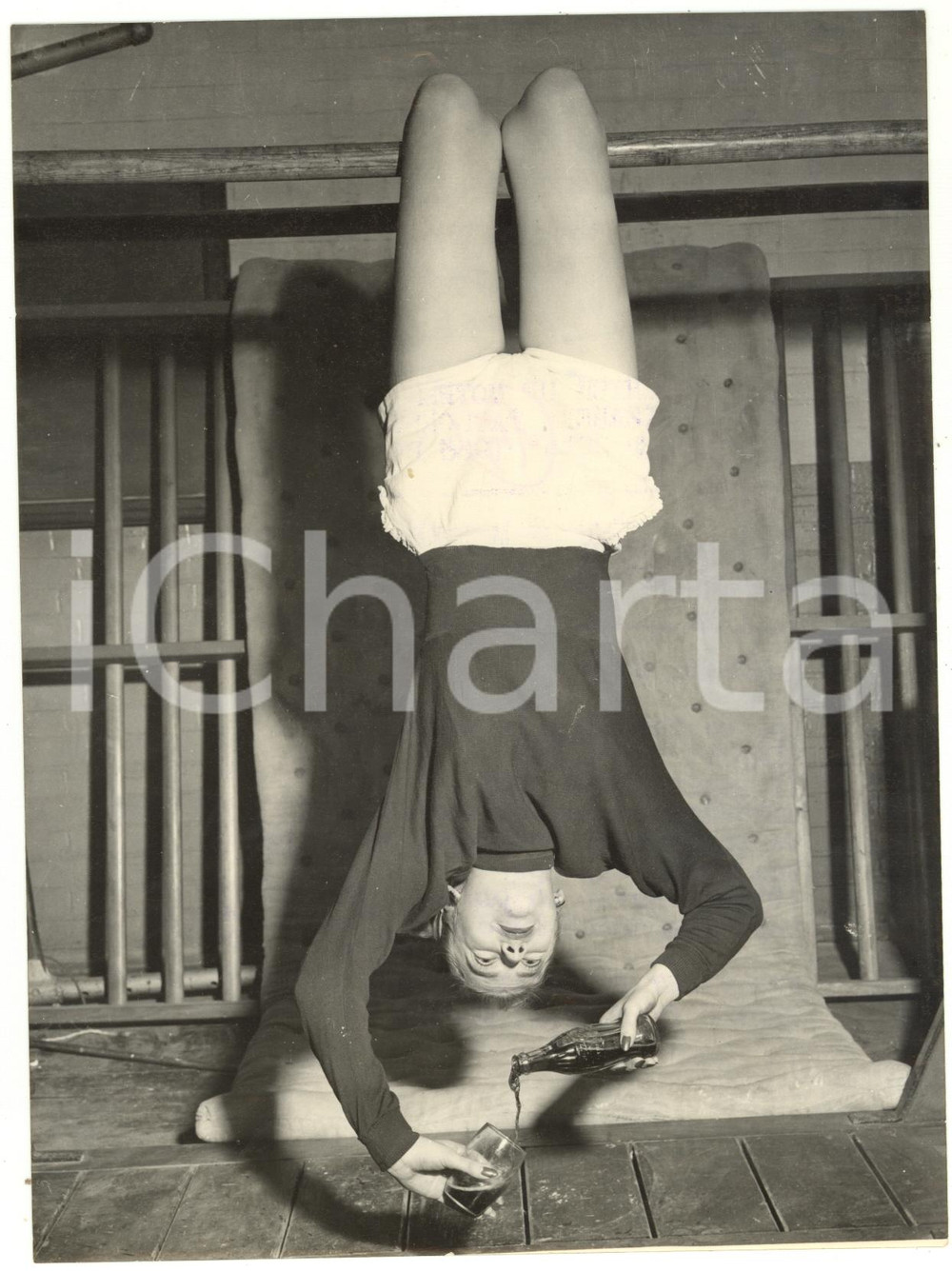 1953 UNITED KINGDOM - The young girl Geraldine pouring a coke upside down *Photo