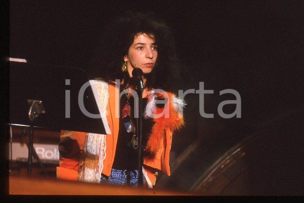 1985 ca MUSICA Teresa DE SIO * 35 mm vintage slide (13) Diapositiva d'epoca, in formato 35 mm.CONDIZIONI: GOODE' severamente vietata la riproduzione. Tutti i diritti sono riservati.ICharta mette in vendita, sul negozio eBay e in esclusiva sul sito "icharta" il proprio archivio composto da numerose diapositive e negativi fotografici d'epoca, tutti originali e autentici, che attraversano la storia del costume italiano tra gli la fine degli anni Sessanta e Novanta.Si tratta di uno sguardo inedito sull'attualità , la politica, la vita quotidiana, il gossip e la cultura, che fotografa il cambiamento della nazione in quest'ultimo scorcio del XX secolo. Un'occasione unica per il mercato del collezionismo, che vede finalmente disponibile un archivio eccezionale per vastità , tematiche e condizioni, in un settore (il negativo fotografico e la diapositiva) di assoluta novità e dalle interessanti prospettive di investimento. GOOD/buono   originale e autentica 1