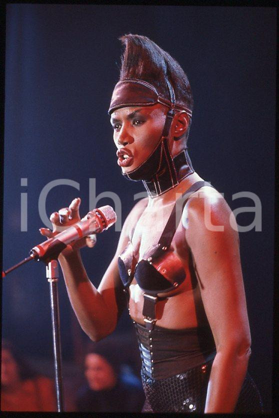 1985 ca MUSICA Grace JONES durante un concerto * 35 mm vintage slide (17) Diapositiva d'epoca, in formato 35 mm.CONDIZIONI: GOODE' severamente vietata la riproduzione. Tutti i diritti sono riservati.ICharta mette in vendita, sul negozio eBay e in esclusiva sul sito "icharta" il proprio archivio composto da numerose diapositive e negativi fotografici d'epoca, tutti originali e autentici, che attraversano la storia del costume italiano tra gli la fine degli anni Sessanta e Novanta.Si tratta di uno sguardo inedito sull'attualità , la politica, la vita quotidiana, il gossip e la cultura, che fotografa il cambiamento della nazione in quest'ultimo scorcio del XX secolo. Un'occasione unica per il mercato del collezionismo, che vede finalmente disponibile un archivio eccezionale per vastità , tematiche e condizioni, in un settore (il negativo fotografico e la diapositiva) di assoluta novità e dalle interessanti prospettive di investimento. GOOD/buono   originale e autentica 1
