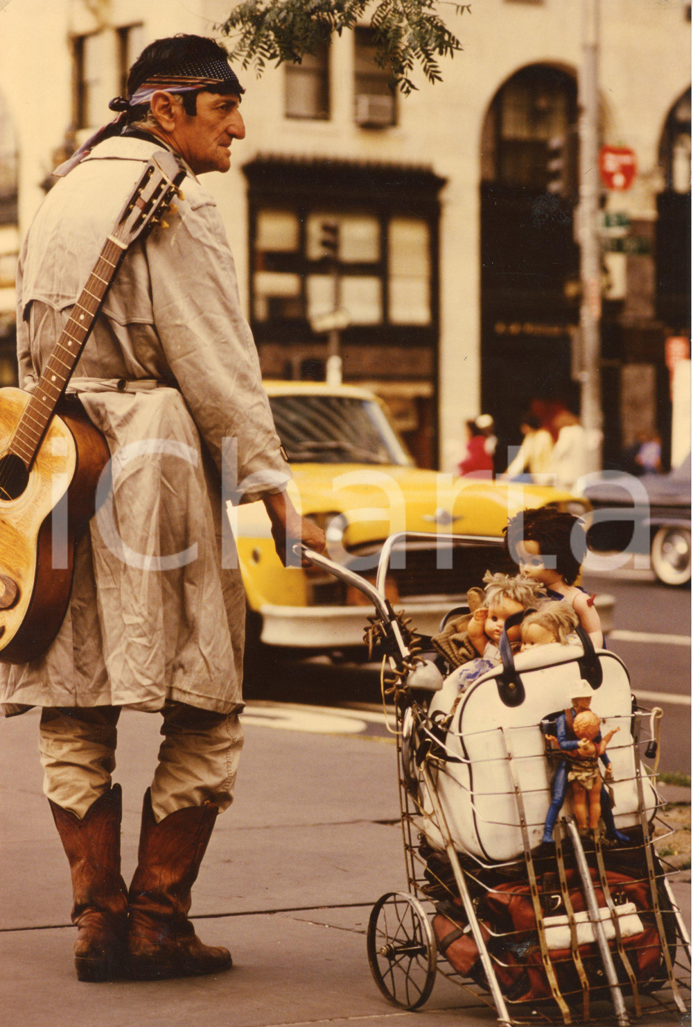 1975 ca USA Homeless with guitar and a trolley full of dolls - Photo 20x30 cm Fotografia d'epoca. FAIR/discreto Residui di incollatura al verso Formato: 20x30 cm originale e autentica 1