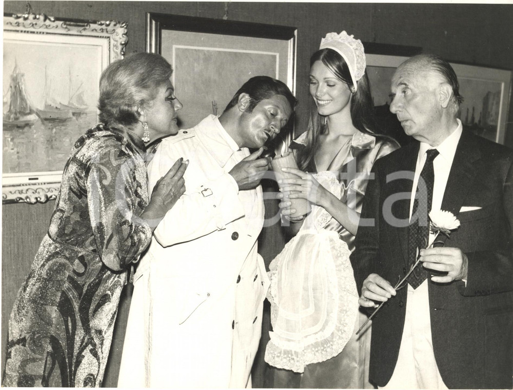 1968 SANTA MARGHERITA LIGURE Nino DEL FABBRO contesta mostra Stefano Cangemi Fotografia d'epoca, con didascalia dattiloscritta coeva al verso.Nino del Fabbro contesta l'arte tradizionalista recandosi alla mostra di Stefano Cangemi con una candela accesa. Nella foto &egrave; accompagnato da Vera Worth, Brigitta Ramang e Cesare Bettarini.  CONDIZIONI: GFORMATO: 24x18 cm       originale e autentica 1