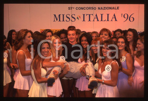35mm vintage slide* 1996 MISS ITALIA Jury CHECHI in braccio alle concorrenti (1)  Diapositiva d'epoca, in formato 35 mm.  CONDIZIONI: GOOD Tutti i diritti riservati.E' severamente vietata la riproduzione. ICharta mette in vendita, sul negozio eBay e in esclusiva sul sito "icharta" il proprio archivio composto da numerose diapositive e negativi fotografici d'epoca, tutti originali e autentici, che attraversano la storia del costume italiano tra gli la fine degli anni Sessanta e Novanta.Si tratta di uno sguardo inedito sull'attualit&agrave;, la politica, la vita quotidiana, il gossip e la cultura, che fotografa il cambiamento della nazione in quest'ultimo scorcio del XX secolo. Un'occasione unica per il mercato del collezionismo, che vede finalmente disponibile un archivio eccezionale per vastit&agrave;, tematiche e condizioni, in un settore (il negativo fotografico e la diapositiva) di assoluta novit&agrave; e dalle interessanti prospettive di investimento.  originale e autentica 1