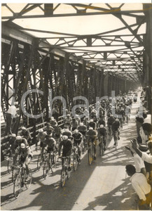 1955 ca CICLISMO GIRO D'ITALIA BASSANO DEL GRAPPA Passaggio sul ponte - Foto  Fotografia d'epoca con didascalia coeva.  CONDIZIONI: FAIR (piccola macchia al centro e al lato destro) FORMATO: 13x18 cm     originale e autentica 1