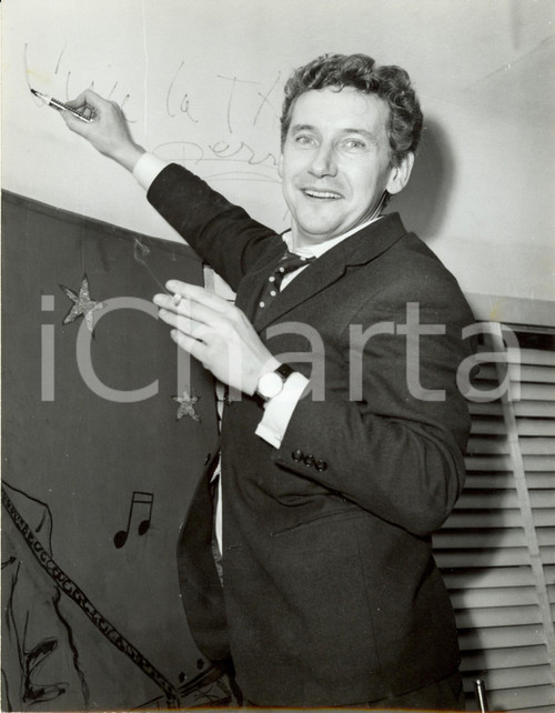 1960 ca PARIS Cantante Pierre PERRIN autografa la parete di un locale ^Foto DATA: 1960 circaLUOGO: PARIGITITOLO: IL CANTANTE PIERRE PERRIN LASCIA IL SUO AUTOGRAFO SULLA PARETE DI UN LOCALE DESCRIZIONE: Fotografia d'epoca. AUTORE: Agence Lynx - Paris.FORMATO: 18 x 24 cm CONDIZIONI: buone  Vera fotografia d'epoca, originale, autentica.   originale e autentica 1
