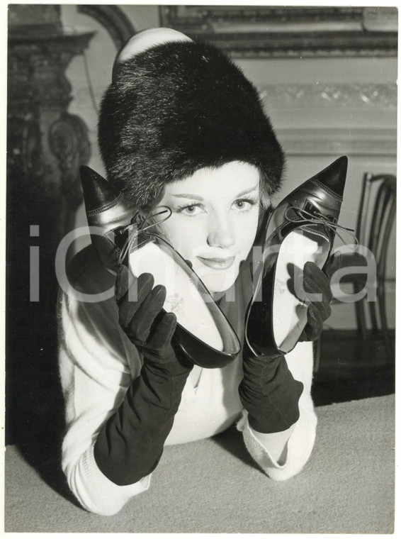 1960 LONDON - Sally ROBINS holding up shoes by HOLMES in contrasting materials