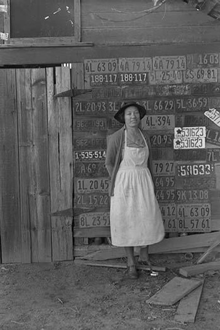 Farm woman beside her barn door