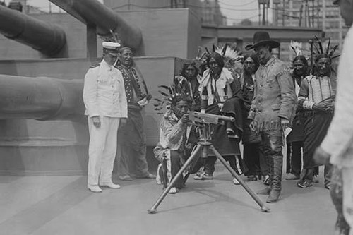 On Board, the "Recruit' a Native American aims a machine gun.