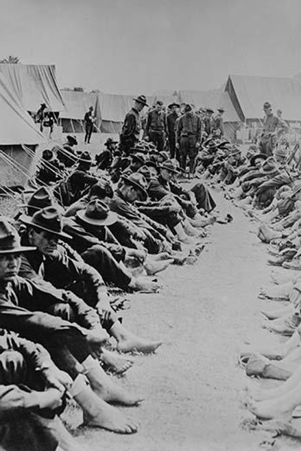 Foot Inspection, soldiers sit on ground while doctors prepare to examine a full unit at once