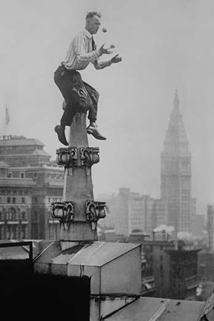 Reynolds Juggles balls on the Pinnacle of a roof high above New York City