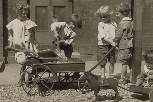 Children Load stones in Wagon with Shovel