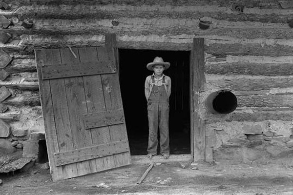 Farm boy in doorway of tobacco barn