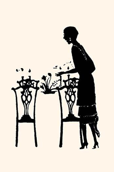 Homemaker sets table with a bouquet of flowers