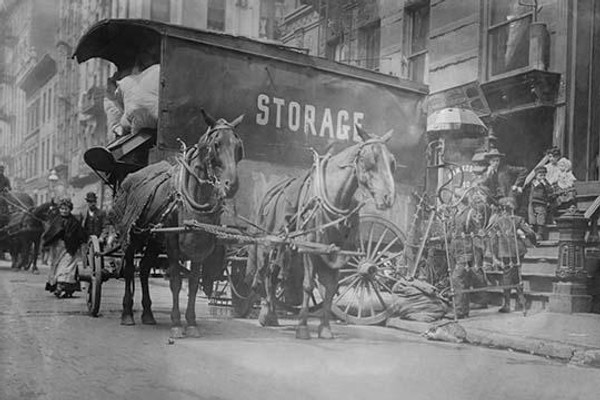 Horse Drawn Wagon with sign saying STORAGE unload the home content of a family being evicted