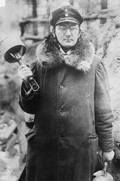 German Soldier holds two Russian Potato Masher Hand Grenades