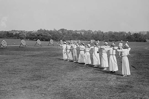 Woman's Archery Team Fires Arrows at a line of targets