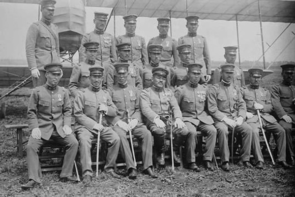 Graduating Class of Japanese Aviators in Uniform with Ceremonial Swords seated in front of Airplane